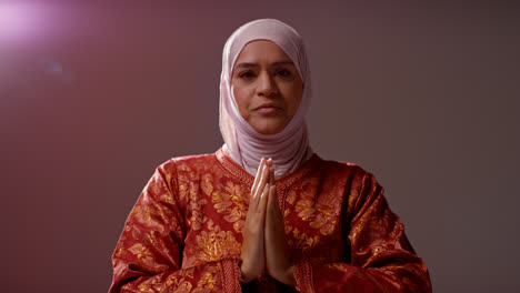 Studio-Head-And-Shoulders-Portrait-Of-Muslim-Woman-Wearing-Hijab-Praying-10